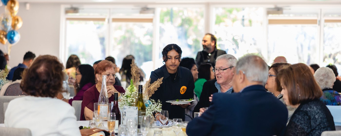 Nuance Food staff serving guests at a seated event